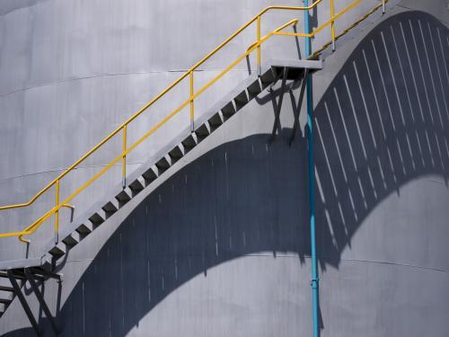 Long shadows of stairs going up a circular tank