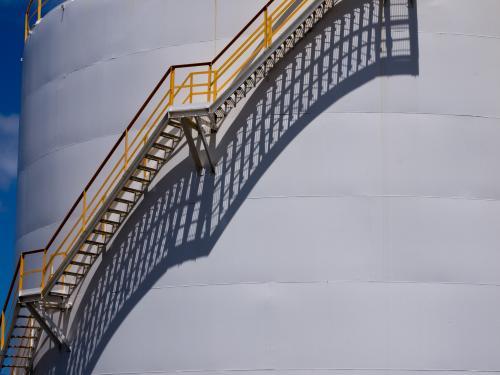 Long shadows of stairs up the side of a large tank - Australian Stock Image