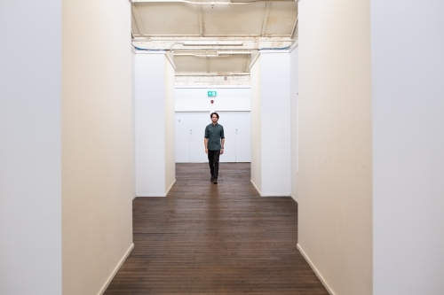 Long shot of a man in a renovated urban building - Australian Stock Image