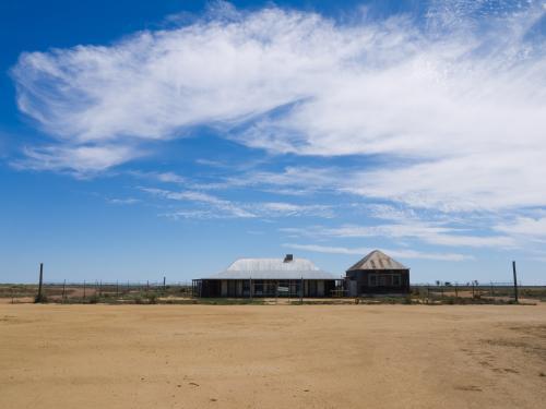 Long shot of One Tree Hill Hotel with a big sky - Australian Stock Image
