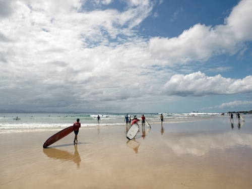 Longboard surfers walking to a surf break - Australian Stock Image