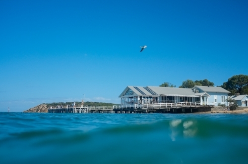 Looking across water at wharf restaurant - Australian Stock Image