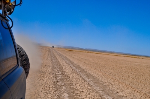 looking back traveling on a dirt road - Australian Stock Image