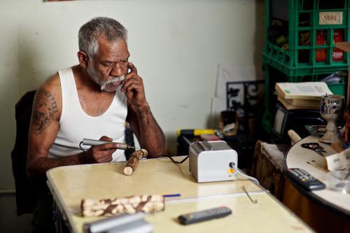 Looking down at an Aboriginal Artist at Work - Australian Stock Image