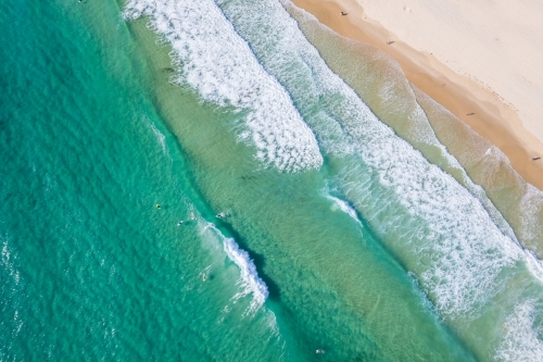 Looking down at paddler boarders in the surf - Australian Stock Image