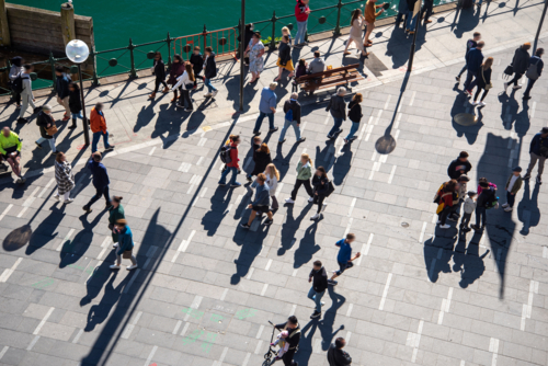 Looking down at pedestrians and their shadows along the waterfront at Circular Quay - Australian Stock Image