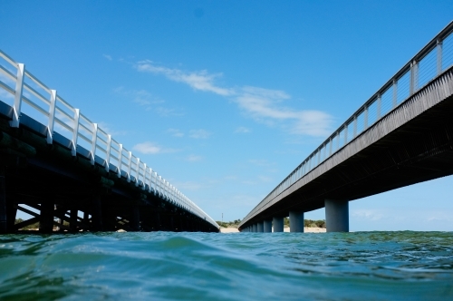 Looking down between two wharfs / bridges back toward land - Australian Stock Image