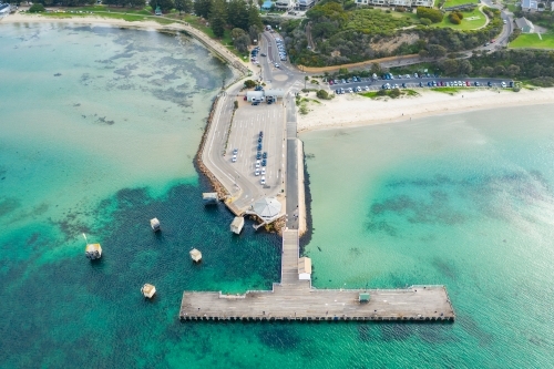 Looking down on a ferry terminal and jetty off a coastal town - Australian Stock Image