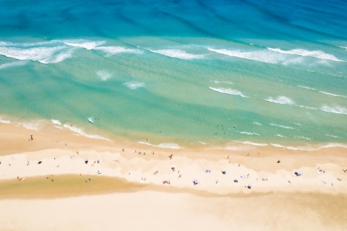 Looking down on a populated beach of swimmers - Australian Stock Image