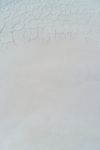 Looking down on the pattern and texture of cracks on the surface of a dry salt lake. - Australian Stock Image