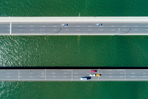 Looking down on traffic on two bridges.