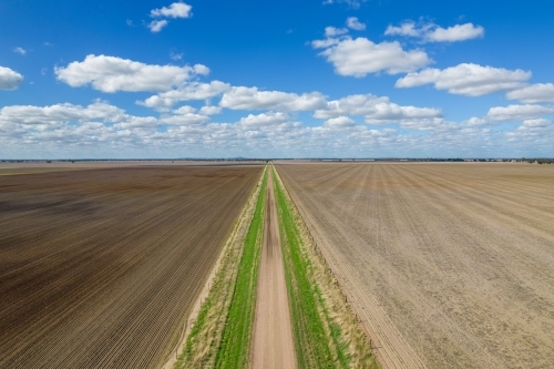 Looking down over a dirt road leading into the distance - Australian Stock Image