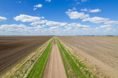 Looking down over a dirt road leading into the distance - Australian Stock Image