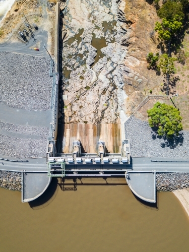 Looking down over the gates and dam wall of a water reservoir
