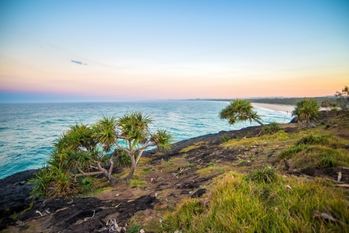 Looking out to the coloured sky to the ocean at Fingal Beach - Australian Stock Image