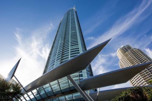 looking up at a skyscraper with blue sky behind