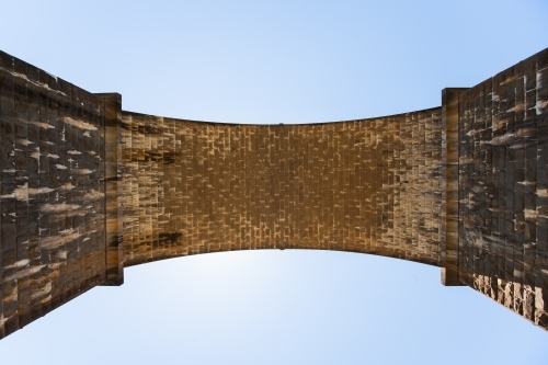 Looking up to the arch of a railway bridge - Australian Stock Image