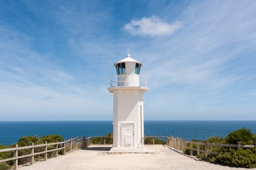 Lookout and lighthouse against a blue sky and ocean - Australian Stock Image