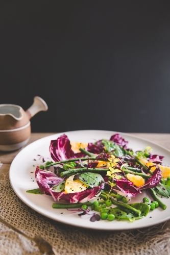 Low angle of a healthy, colourful mixed leaf salad with dark backdrop - Australian Stock Image