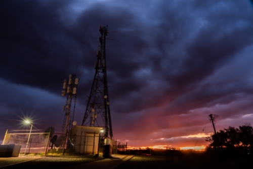 Low angle shot of telecom tower during overcast sunset - Australian Stock Image