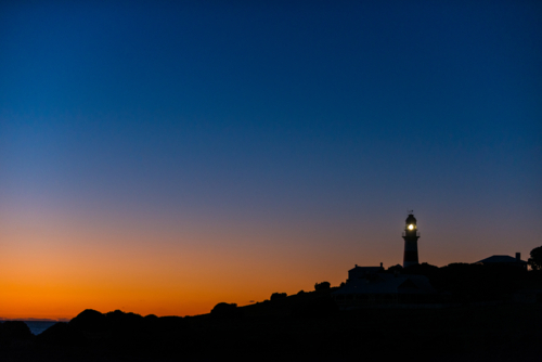 Low Head Lighthouse illuminated at dawn, Tasmania - Australian Stock Image