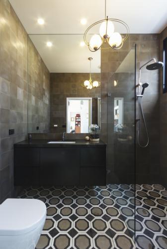 Luxury designer bathroom in contemporary new home extension in dark masculine tones