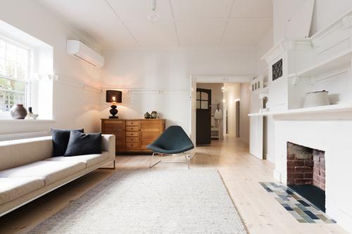 Luxury living room interior styled in contemporary furnishings with fire place - Australian Stock Image