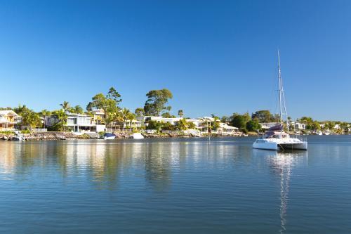 Luxury waterfront living with boat in foreground - Australian Stock Image