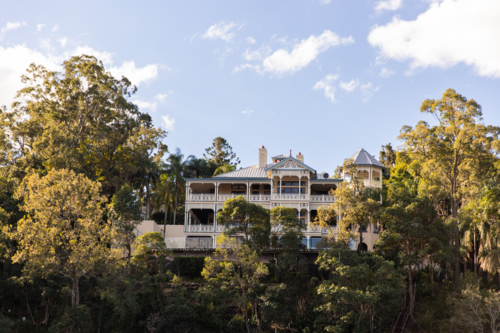 majestic stately home surrounded by gum trees - Australian Stock Image