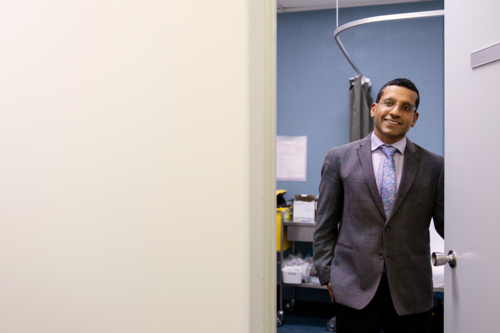Male doctor opening clinic door - Australian Stock Image