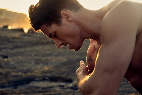 Male person exercising in the morning with workout routine - Australian Stock Image