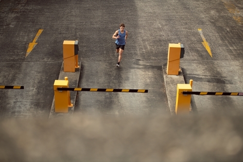 Male runner running through urban setting - Australian Stock Image