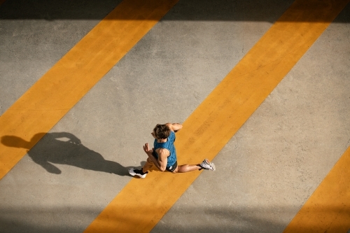 Male runner running through urban setting - Australian Stock Image