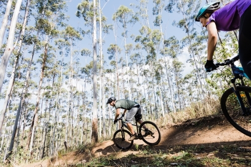 man and woman cyclist riding their bicycle on a mountain bike trail