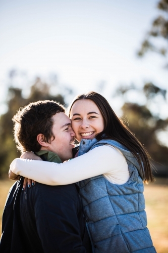 Man and woman laughing and cuddling - Australian Stock Image