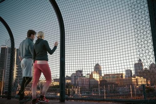 Man and woman resting looking at the cityscape - Australian Stock Image