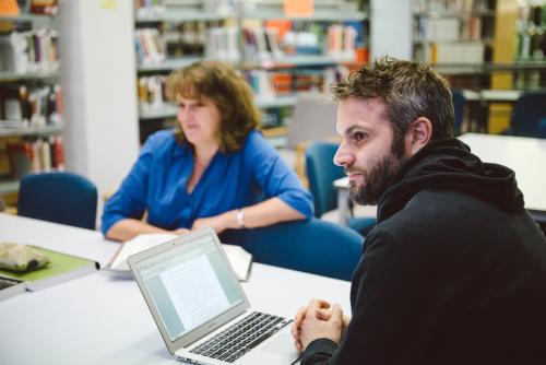 Man and woman studying in the university library - Australian Stock Image