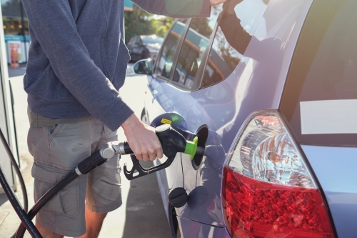 Man filling up car at petrol station with petrol - Australian Stock Image
