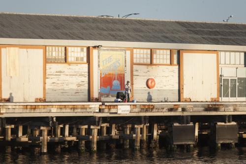 Man fishing from a pier at Fremantle Ports - Australian Stock Image