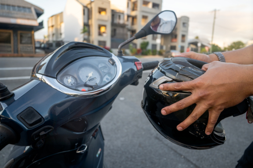 Man getting ready to drive his motorbike, close-up - Australian Stock Image