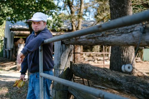 Man Holding open Farm Gate - Australian Stock Image