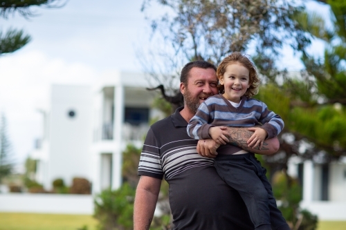 man holding up young child - Australian Stock Image