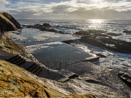 Man in an ocean pool at early morning - Australian Stock Image