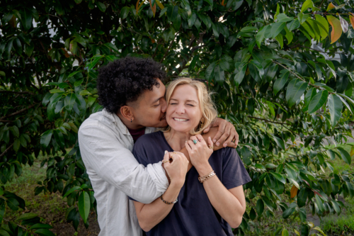 Man kisses girlfriend, young happy and in love couple - Australian Stock Image
