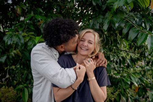 Man kisses girlfriend, young happy and in love couple - Australian Stock Image