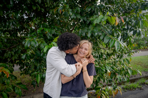 Man kisses girlfriend, young happy and in love couple - Australian Stock Image