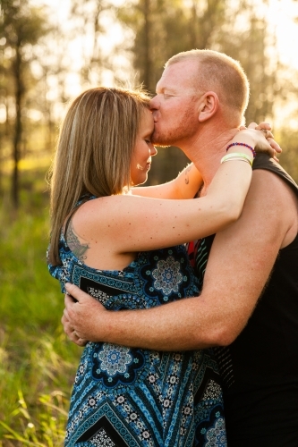 Man kissing woman on forehead - Australian Stock Image