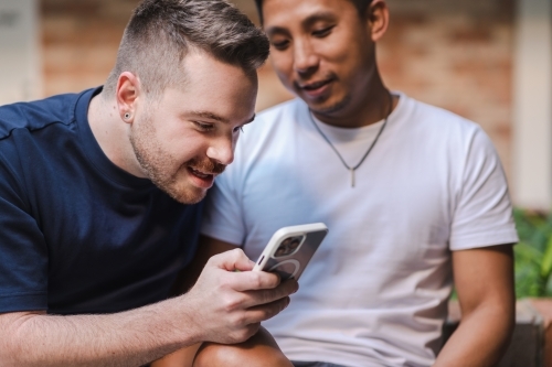 man looking at phone screen - Australian Stock Image