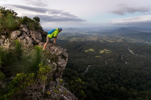 Man looking out from mountain top - Australian Stock Image