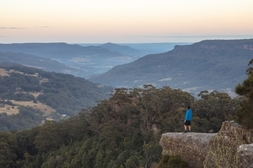 Man looking out over mountains - Australian Stock Image